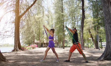 Young couple engaging in stretching exercises with resistance bands