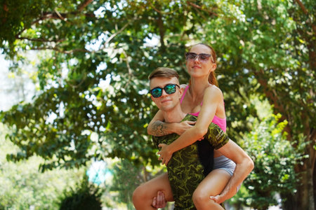 A man and a woman wearing stylish sunglasses in a parkの写真素材