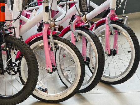 A variety of bicycles are hanging on a rack inside a sport store