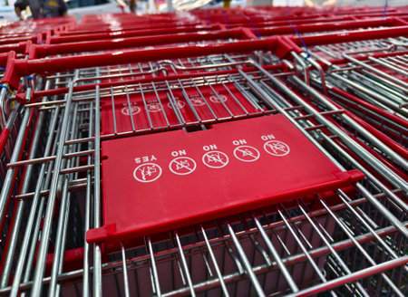 A row of shopping carts is neatly lined up in a straight rowの写真素材