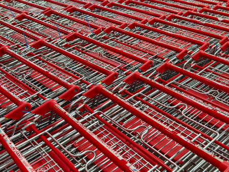 A row of shopping carts is neatly lined up in a straight rowの写真素材