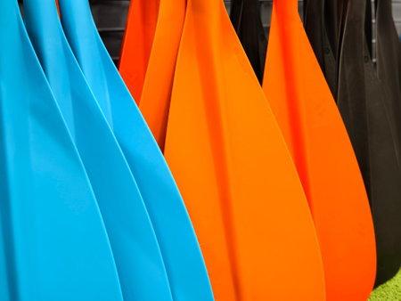 A collection of oars is lined up neatly in a row for useの写真素材