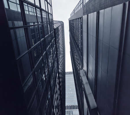 Striking row of tall towering glass buildings in a vibrant cityの写真素材