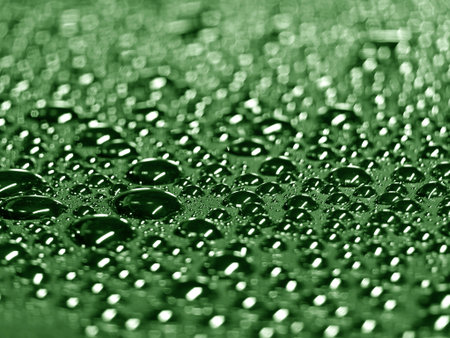 A detailed closeup view showcasing water droplets on a blue surfaceの写真素材