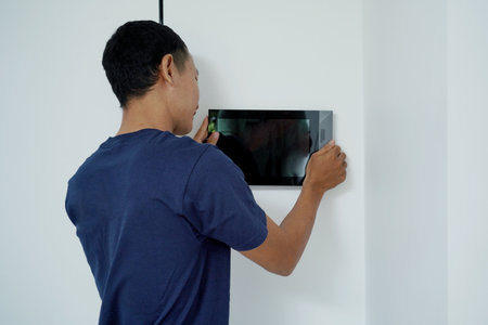 Worker with tablet computer checking alarm systemの写真素材
