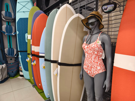 A collection of various surfboards are neatly lined up in a storeの写真素材