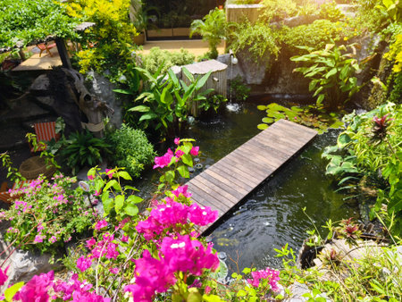 Serene pond complete with a beautiful waterfall and fish swimming gracefully