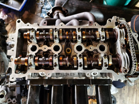 A car engine is being worked on inside a garage workshop