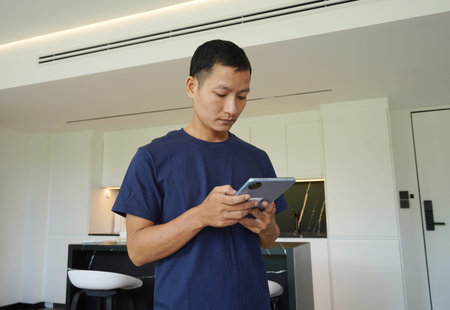 Worker with tablet computer checking alarm system