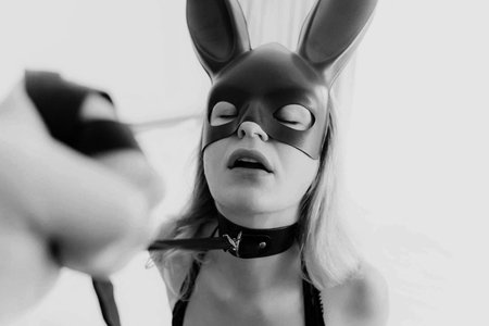 Young woman with black mask posing