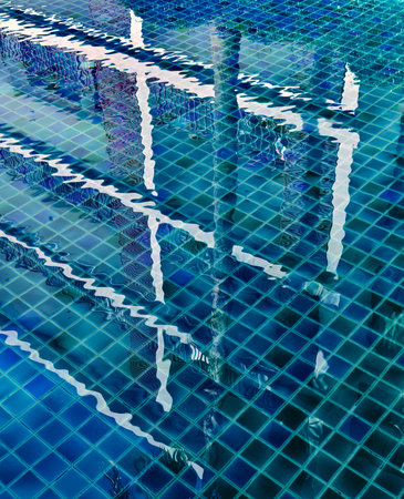 Reflections seen in a calm pool surface of waterの写真素材