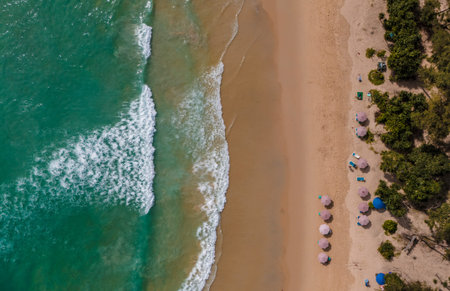 Top view beach with waves crashing on sandy shoreの写真素材