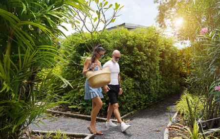 A man and a woman are leisurely walking down a scenic path at the glampingの写真素材