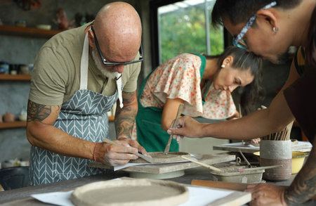 A happy couple makes ceramic plates in a workshop