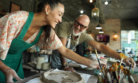 A happy couple makes ceramic plates in a workshop