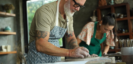 A happy couple makes ceramic plates in a workshop