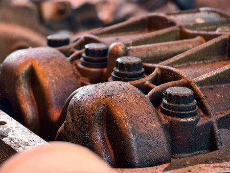 Rusted engine parts and corroded gears scattered across the sandy ground
