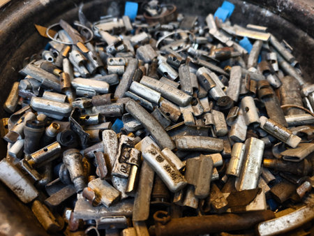 Pile of rusted motor components and gears in cluttered scrap heap