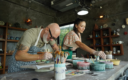 A happy couple makes ceramic plates in a workshopの写真素材