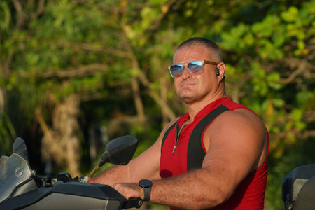 A man engages in extreme ATV riding on sand beach early in the morningの写真素材