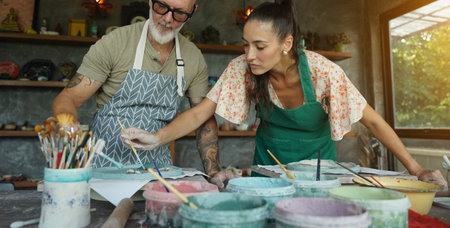 A happy couple makes ceramic plates in a workshop
