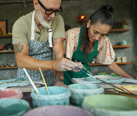 A happy couple makes ceramic plates in a workshop