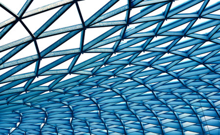 Glass canopy showcasing repeating geometric frames and day light