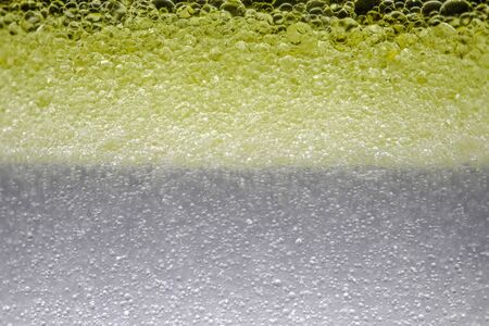 bubbles in yellow micellar water as background. High quality photoの写真素材