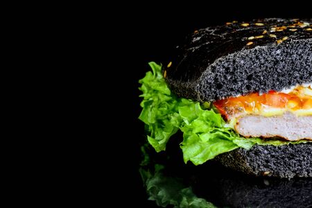 black hamburger close up on a black background . High quality photoの写真素材
