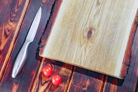 cutting Board with a knife and tomatoes top viewの写真素材