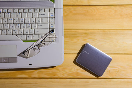 laptop on a wooden background top view