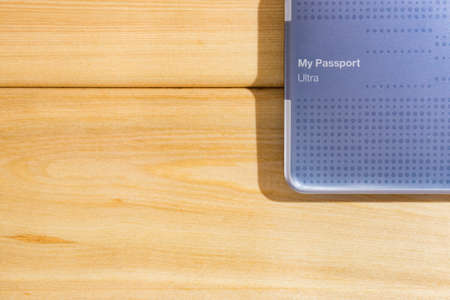 external hard drive on a wooden background top viewの写真素材