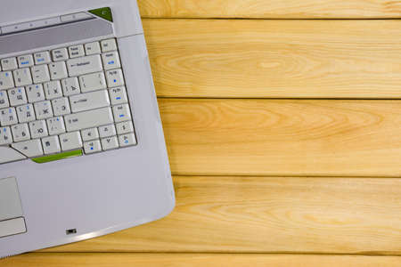 laptop on a wooden background top viewの写真素材