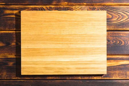 cutting Board on a wooden background top viewの写真素材