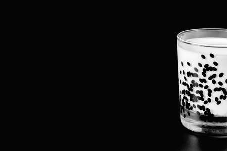 a glass of milk on a black background. health food. isolate. High quality photoの写真素材