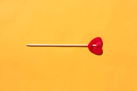 arrow with a heart on a yellow background. isolate. place for the label. High quality photoの写真素材