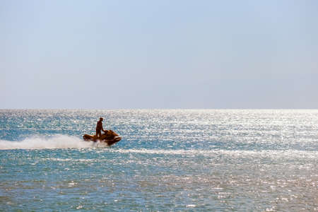 a man rides a jet ski in the open seaの写真素材
