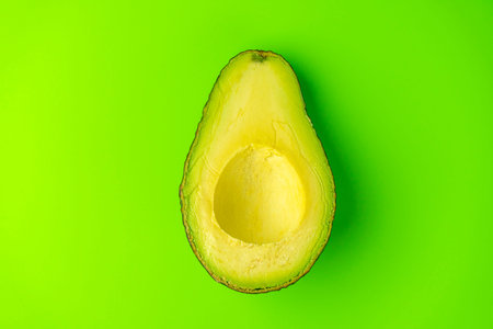avocado on a green background close-up. isolate