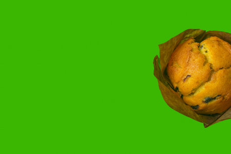 muffin on a green background close-up. isolate