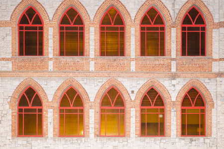 stone wall with red Windows as backgroundの写真素材