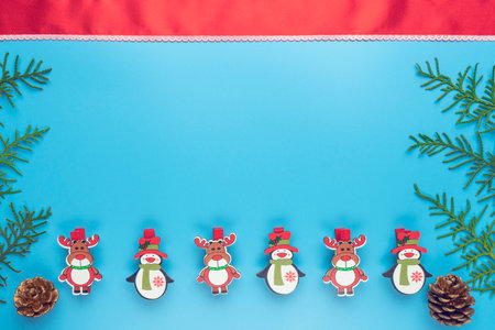 new years card. toys and branches of thuja on a blue background. childrens new years theaterの写真素材