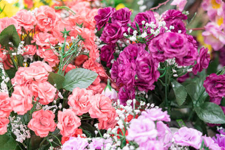 artificial multicolored flowers close up as backgroundの写真素材