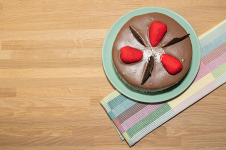 chocolate cake and towel on wooden background