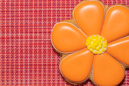 ginger cookies in the form of a flower on a red backgroundの写真素材