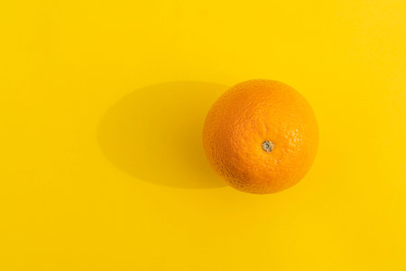 orange with a hard shadow on a colorful backgroundの写真素材