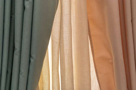 multicolored textures of fabrics on the shelves of stores close-upの写真素材