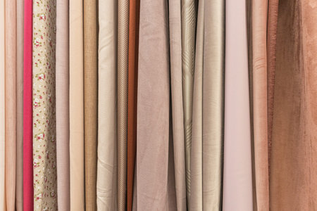multicolored textures of fabrics on the shelves of stores close-up