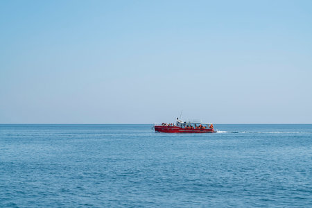 a pleasure boat moves along the sea horizon