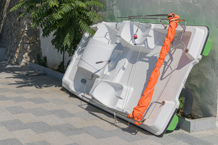 the catamaran is moored against the wall