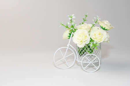 white flowers in a bicycle basket on a white backgroundの写真素材